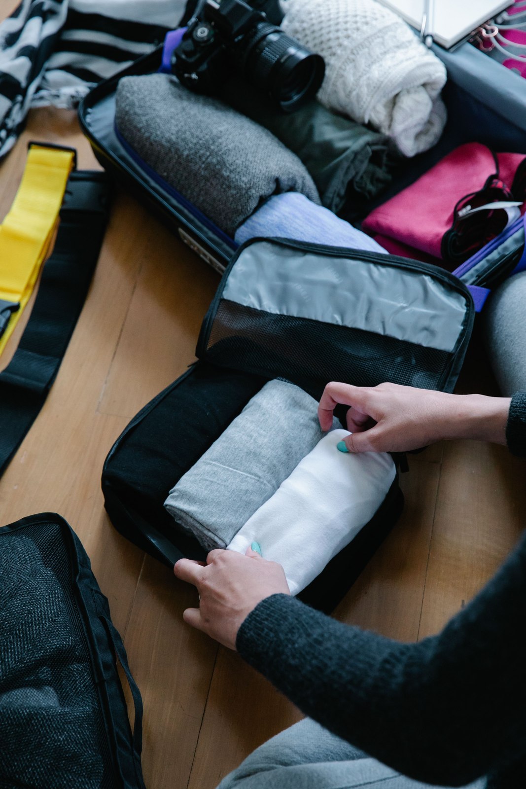 Packing clothes into a packing cube