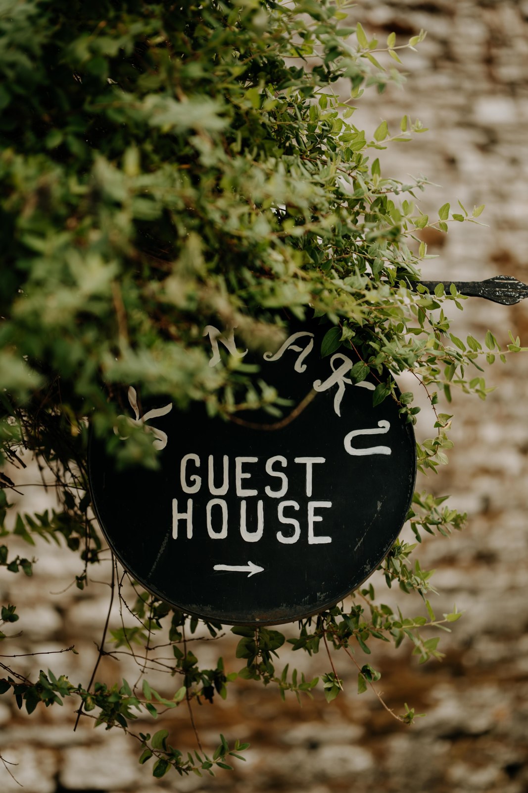 Guesthouse sign surrounded by greenery