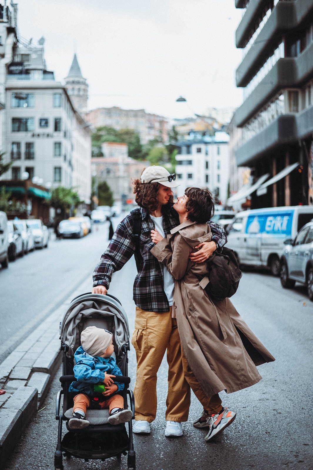 Family with a pushchair in a city