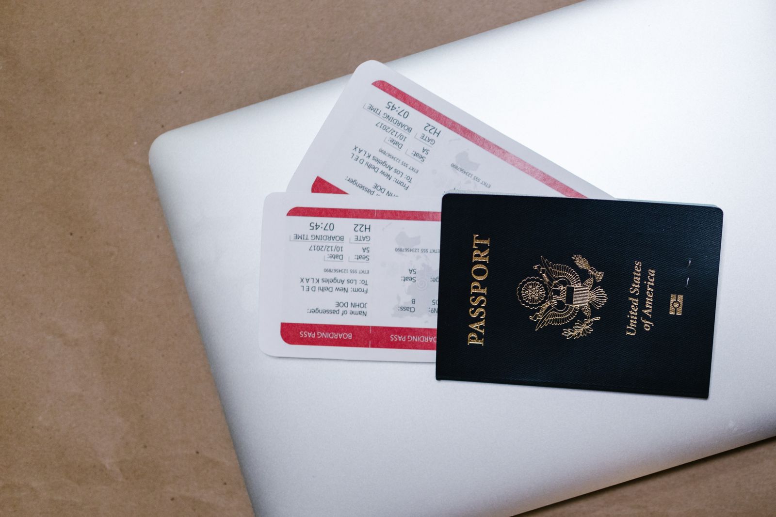 Passport and flight documents on a laptop