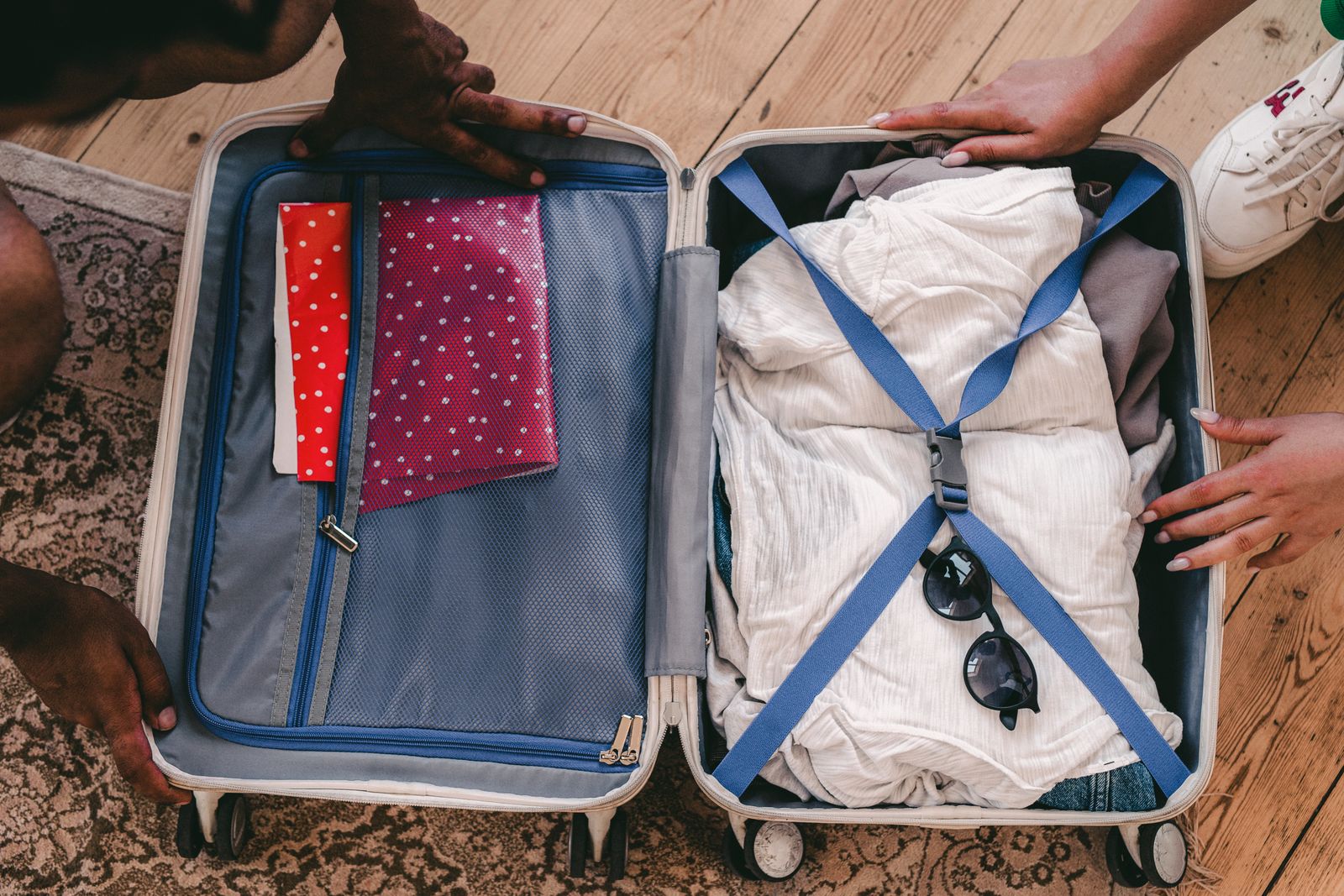 Clothes and sunglasses in an open suitcase