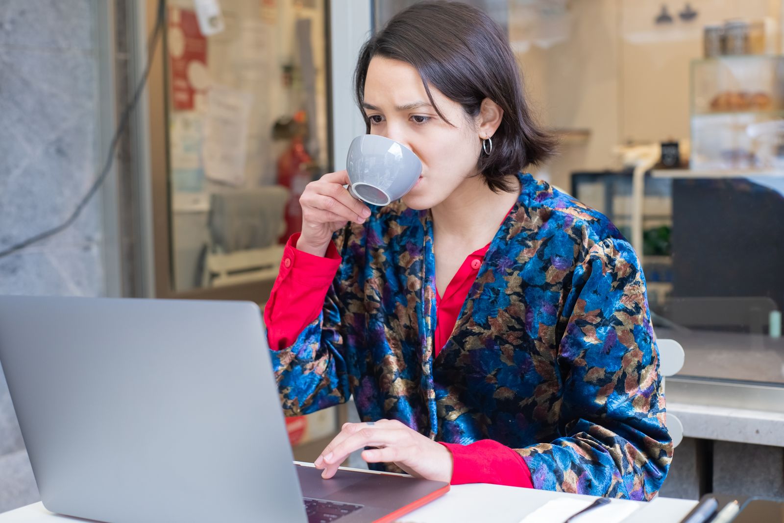 A woman using a laptop in a cafe